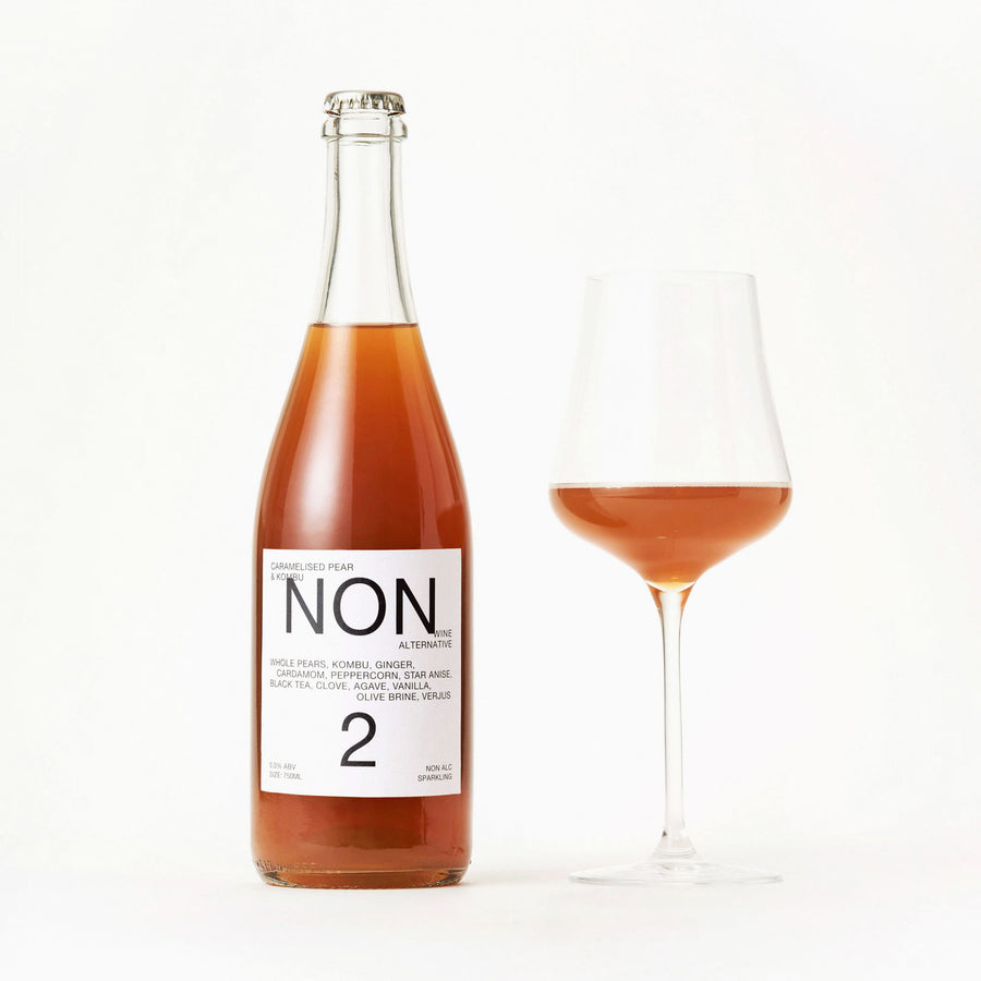 NON2 Caramelised Pear & Kombu bottle beside a filled wine glass