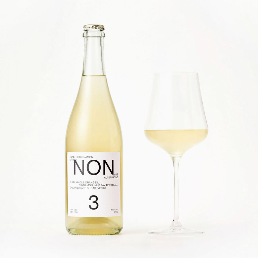 NON3 Toasted Cinnamon & Yuzu bottle beside a filled wine glass