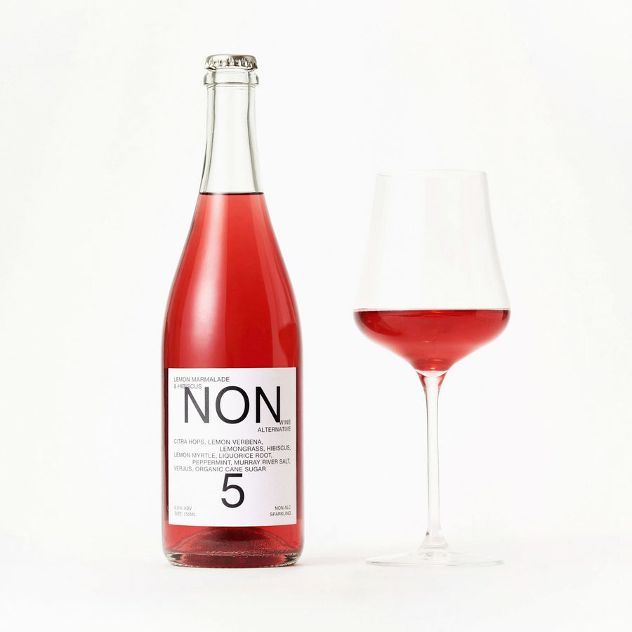 NON5 Lemon Marmalade & Hibiscus bottle beside a filled wine glass