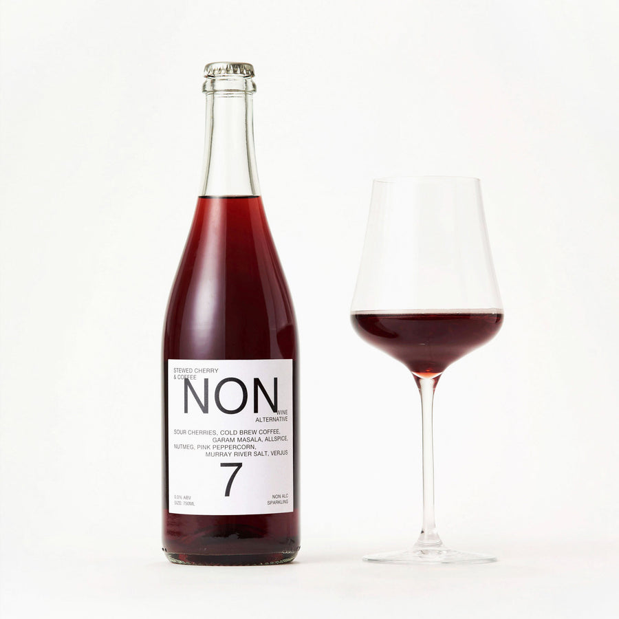 NON7 Stewed Cherry & Coffee bottle beside a filled wine glass